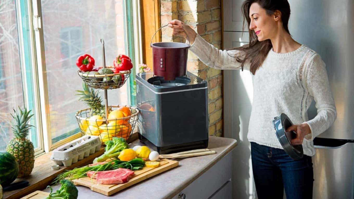 Woman using Vitamix FoodCycler, placed on countertop
