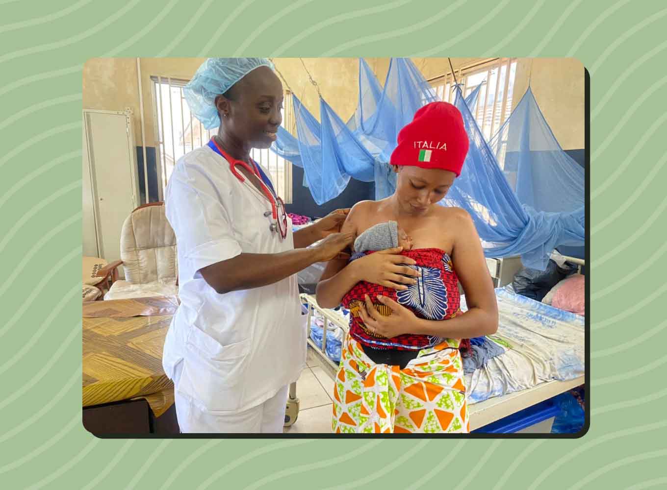 A Sierra Leonean nurse pats the shoulder of a new mom who is holding her baby. 