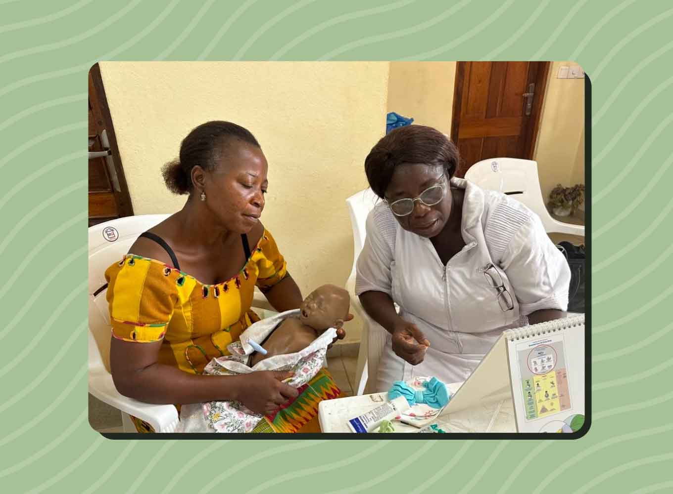 Two African women study neonatal care, one reading educational materials, while the other holds an infant simulator.